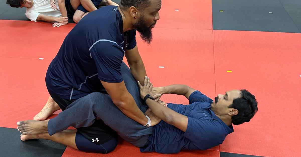 doing hip bump sweep in jiu jitsu class